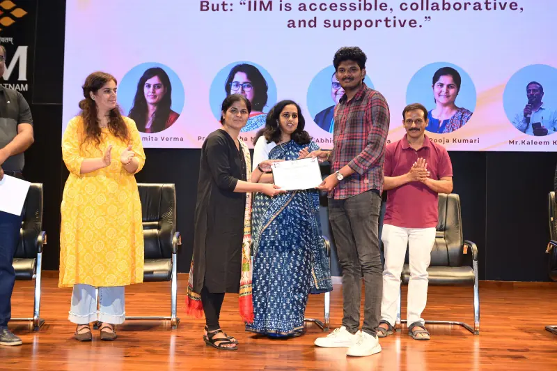 Syam Sundar Yadla receiving a certificate for AI innovation at IIM Visakhapatnam